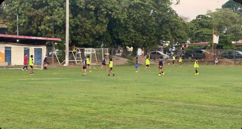 Kids playing on the field during renovation